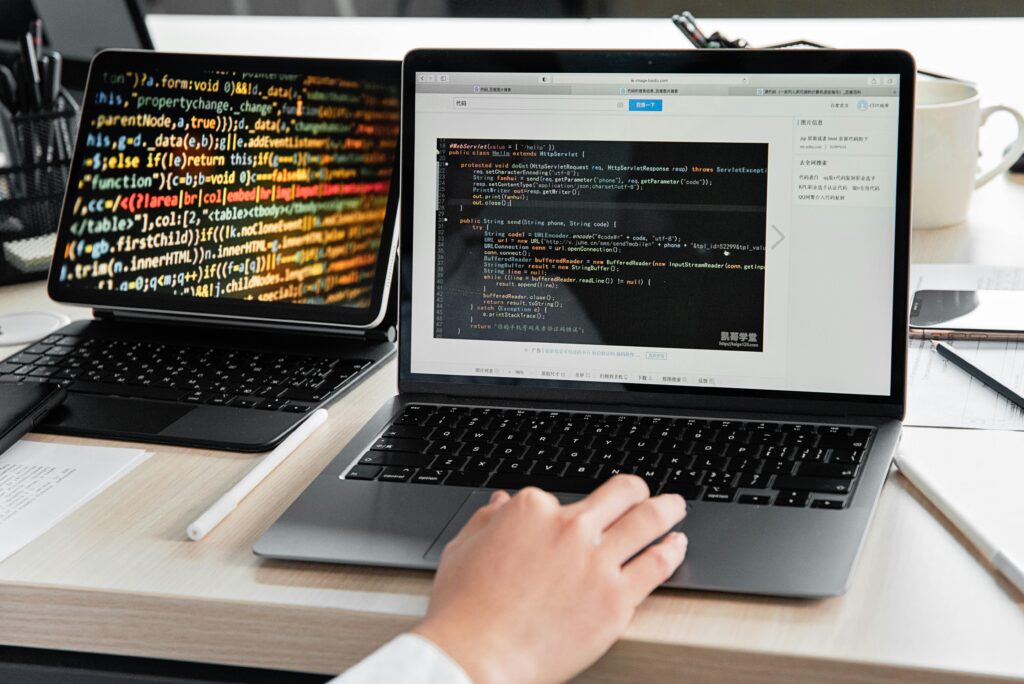 pexels photo 7988114 7988114 A developer writing code on a laptop, displaying programming scripts in an office environment.